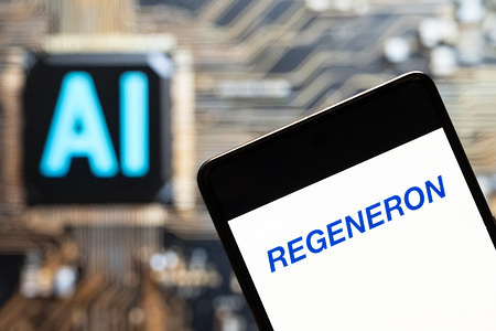 In this photo illustration, the American biotechnology company Regeneron Pharmaceuticals (NASDAQ: REGN), logo seen displayed on a smartphone with an Artificial intelligence (AI) chip and symbol in the background.