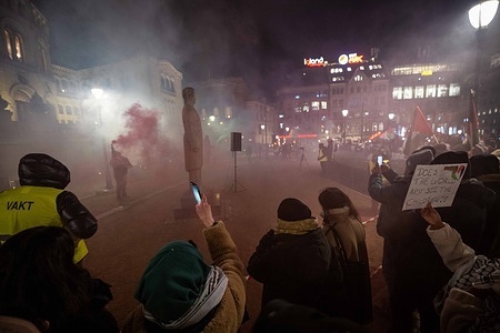 Several activists are seen lighting smoke torches during a rally at the parliament building in downtown Oslo. Collectives and pro-Palestinian groups held several actions at the Parliament building in the Norwegian capital where they demanded a ceasefire and a halt to hostilities by Israel, which has carried out an armed raid on the Gaza Strip.