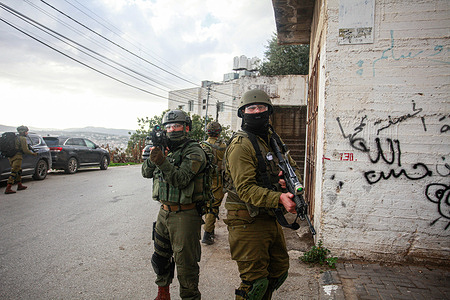 Israeli soldiers take aim during a military operation in the Balata refugee camp, West Bank. The Israeli military forces conducted a raid operation in Batata Refugee camp to arrest wanted Palestinians.