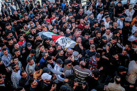 (EDITOR'S NOTE: Image depicts death)
Mourners carry the bodies of five Palestinians, during their funeral in the Balata refugee camp in the occupied West Bank. The Israeli military said its aircraft struck what it described as a hideout for militants in the urban refugee camp of Balata. The Palestinian Red Crescent ambulance service said five Palestinians were killed in the strike.
