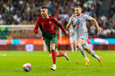 Cristiano Ronaldo (L) of Portugal and Sverrir Ingason (R) of Iceland in action during the Euro 2024 qualifying match between Portugal and Iceland at Alvalade Stadium.Final score; Portugal 2:0 Iceland.
