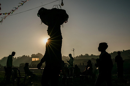 A Nepali Hindu devotee carries a basket as he prepares to return back home from Bagmati River after offerings to the rising sun on the bank of the holy Bagmati river during the Chhath festival. During Chhath, an ancient Hindu festival, rituals are performed to thank the sun god for sustaining life on earth. Chhath Puja is a Hindu festival where devotees pray to the sun god and offer Prasad and special delicacies at sunset and before sunrise. They end their fast by eating 'Prasad' and special delicacies. 