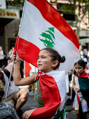 A young child with Palestinian flag facepaint holds and dons Lebanese flags during the demonstration. Hundreds of primary and secondary school students partake in a ‘School Strike,’ walking out of class and meeting in the city centre to express solidarity with the Palestinian cause and to call for an end to the Israel-Hamas war.