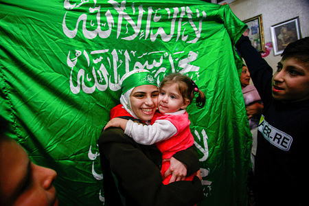 Aseel Atiti, one of the ten Palestinian prisoners released by Israeli forces, embraces her little sister at their home in Balata refugee camp in the West Bank city of Nablus. The release came on the first day of a four-day cease-fire deal between Israel and Hamas, during which the Gaza militants have pledged to release 50 hostages in exchange for 150 Palestinians imprisoned by Israel.
