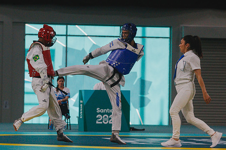 Cicero Do Nascimento of Brazil (Red) and Leandro Fernandez of Argentina (Blue) in action during the Men's Para Taekwondo at the Santiago 2023 Parapan American Games.