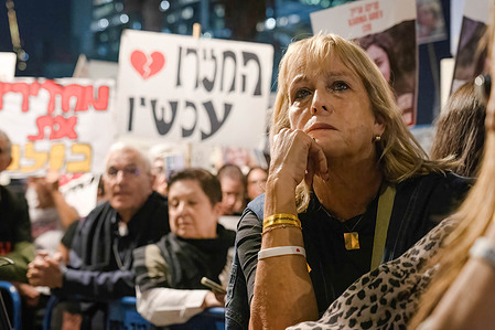 A protester keenly listens to speeches during the rally in Tel Aviv. As Israel and Hamas 4-day truce entered a second day, thousands of Israeli citizens gathered and rallied in Tel Aviv to pay solidarity and demand the release of the remaining hostages held by Hamas in the Gaza Strip. Officials claimed there were 100,000 attendees. The deal agreed on a release of around 50 Israeli hostages out of about 240, in exchange of around 150 Palestinian prisoners.