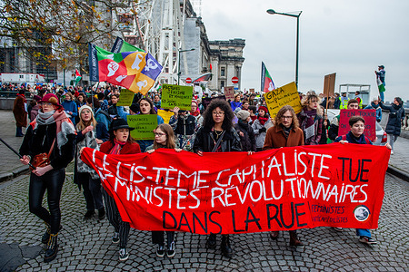 Protesters are seen holding a big red banner against capitalism during the demonstration. On the occasion of the International Day against Violence Against Women, and on the initiative of 'Mirabal Belgium' (a group of several civil society associations) a new National Demonstration to fight against violence against women was held in the Belgium capital. Thousands of people marched to send a strong signal on this day for the elimination of violence against women and make a call to civil society (associations and citizens) to express their rejection of 'machismo' violence.