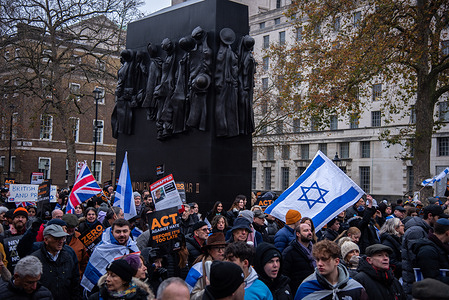 A crowd of protestors march with the Flag of Israel and placards during the March Against Antisemitism As antisemitism surges, Britain stands together in solidarity with its Jewish community.