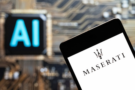 In this photo illustration, the Italian luxury car manufacturer Maserati logo seen displayed on a smartphone with an Artificial intelligence (AI) chip and symbol in the background.