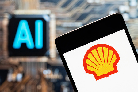 In this photo illustration, the Anglo-Dutch global group of energy and petrochemical company Shell logo seen displayed on a smartphone with an Artificial intelligence (AI) chip and symbol in the background.