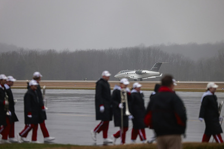 A private jet arrives at the Monroe County Airport carrying recently hired Indiana University football coach Curt Cignetti in Bloomington. The plane was met by IU Red Steppers, a band, and a large number of public relations officials. The media was kept behind a fence for the “private event.”