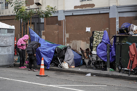 The belongings and tents of homeless people are seen on the street. The issue of homelessness remains a significant concern in San Francisco, California, with thousands of individuals living on the streets. Many of the homeless population are linked to various crimes, including drug-related activities and instances of theft. A policy has been implemented that providing homeless individuals with a minimum of 15 minutes to decide whether they wish to accept the city's offer of shelter.