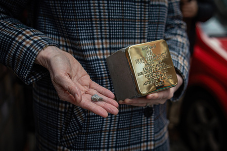 A participant holds a Stolpersteine before its installation. This morning new units of "Stolpersteine" were placed in Madrid, this time in the Arganzuela neighborhood, to remember the Spanish republicans, deported to Nazi extermination camps and originating from this neighborhood of Madrid. The Stolpersteine project is the work of German artist Gunter Demnig, in tribute to any victim of Nazism between 1933 and 1945, including Spanish deportees.