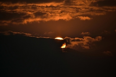 The sun sets behind the clouds on a cold winter evening in Srinagar, the summer capital of Jammu and Kashmir.