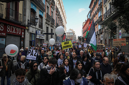 Dozens of protesters walk during a new demonstration through the streets of central Madrid in support of the Palestinian people and in condemnation of the state of Israel.