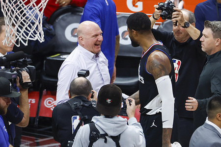 Los Angeles Clippers' Paul George (R) celebrates with Steve Ballmer (L) after their win against the Golden State Warriors during an NBA basketball game at Crypto.com Arena. Clippers won 113-112.