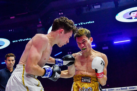 Professional boxer Giuliano Fantone (left) on the attack against popular Thai Youtuber Supphoolphol Tipphol (right) also known as "Joker" during their professional boxing bout.