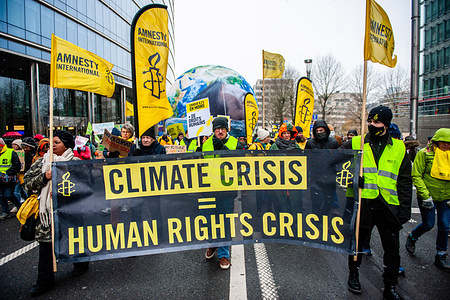 Protesters from the organization Amnesty International are seen marching while holding a banner in support of human rights during the demonstration. Thousands of people gathered at the Brussels North station to protest against the lack of action on the climate crisis during a march organized by The Climate Coalition (an organization that unites more than 90 organizations around the theme of climate justice). With this march, they demand that Belgium and Europe finally put themselves in working order to make the industry sustainable, improve the quality of public transport, insulate homes, and restore nature.