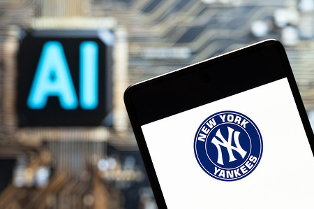 In this photo illustration, the American professional Major baseball team league (MLB) the New York Yankees (NYY) logo seen displayed on a smartphone with an Artificial intelligence (AI) chip and symbol in the background.