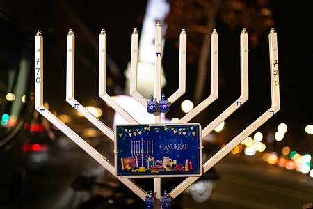 A candelabrum Hanukkiah seen during the Hanukkah festivities at Place de Bastille. The fifth day of Hanukkah festivities in Paris took place at Place de Bastille. Hanukkah is a Jewish festival that commemorates the recovery of Jerusalem. The festival is observed by lighting the candles of a candelabrum with nine branches, commonly called a menorah or hanukkiah.