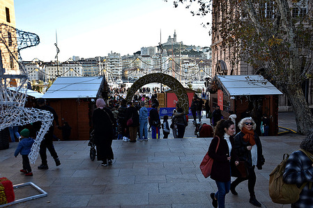 People seen wandering around the children's Christmas village. For the end of year celebrations, the Marseille town hall has set up a Christmas village with attractions for children, including an ice rink and a toboggan run.