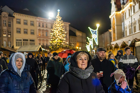 Christian believers attend a midnight mass in the open air on the Upper Square in Olomouc. Midnight Mass is the first liturgy of Christmas Tide celebrated by Christians on the night of Christmas Eve worldwide. Upper Square (Horni namesti in Czech) is a historical square in Olomouc with the Holy Trinity Column, part of the Unesco World Heritage List.