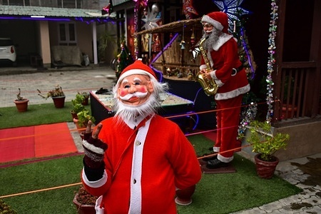 A Christian devotee dressed in Santa Clause costume reacts at the Holy Family Catholic Church during Christmas celebrations in Srinagar.
The Himalayan region of Kashmir has a minuscule population of Christians, hundreds of whom join mass at the Holy Family Catholic church on Christmas and pray for peace and prosperity of the region.