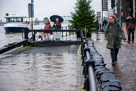 People are seen looking at the sandbags placed along the river to protect the city. Due to the rising water in the IJssel River, the municipality of the Deventer is placing sandbags on the quay to protect the old city center. The heavy rain that has been falling during these last months combined with the fact that the Alps are unusually warm for this time of year, has created the IJssel river to flood in Overijssel, Gelderland, Drenthe, Brabant, and Limburg.