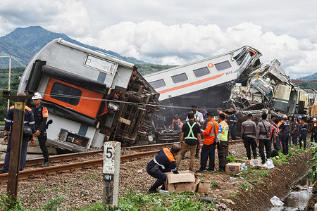 Passengers were being evacuated after the crash on the island of Java, which killed at least three people, according to a local official. Nearly 500 passengers were evacuated on Friday morning after two trains collided on the edge of a rice field near the Indonesian city of Bandung, killing at least three people and injuring more than two dozen others, officials said. The accident occurred just after dawn in Rancaekek District, east of the city on the island of Java. Footage from the scene showed mangled train carriages, including at least two that had gone off the rails and into a flooded rice field.