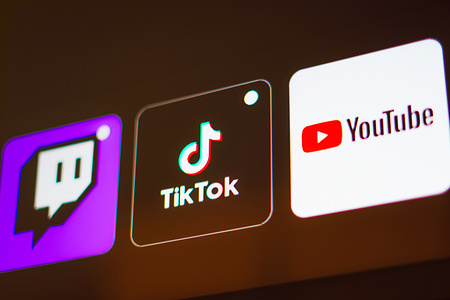 In this photo illustration the TikTok, Twitch and YouTube logo is displayed on a TV screen.