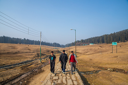 Visitors walk on the pathway with backdrop of meadows at famous tourist resort Yusmarg in Budgam north-east of Srinagar Kashmir. The Kashmir Valley is a globally renowned winter tourist destination due to its ski resorts and mountains. However, the region is currently experiencing an exceptional drought, with a 79% rainfall shortfall from December 2023 to the first week of January, and no snowfall. Meteorological experts associate the absence of rain and snow with El Nino, a natural climate event defined by anomalous warming of Pacific Ocean waters. In the future, scientists warn that the valley may see more regular and extended droughts, which are markers of climate change and might lead to water scarcity and a potential food catastrophe in the region. In addition to damage to tourism, there have been impacts on agriculture harming, for example, saffron producers.