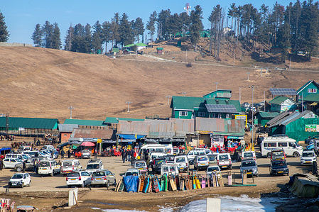 Vehicles are seen parked at the world famed ski resort of Gulmarg on a sunny winter day in Baramulla district. Gulmarg, a key tourist attraction in Kashmir renowned globally for its ski resorts, is experiencing an unprecedented dry spell this year, leaving its ski slopes and scenic landscapes devoid of winter snow. Both weather experts and those dependent on tourism for their livelihood are expressing concern over extended dry spell, impacting the region's economy and the expectations of winter enthusiasts. However the valley is currently experiencing an exceptional drought, with a 79% rainfall shortfall from December 2023. Experts warn that reduction in rain and snowfall might lead to water scarcity and a potential food catastrophe in the region.