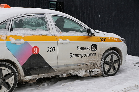 The Evolute i-PRO, a Russian-made passenger car assembled from the Chinese Dongfeng Aeolus E70, and now in operation with Yandex Taxi as an electric taxi, is seen at a high-speed Electric Vehicle Charging station.