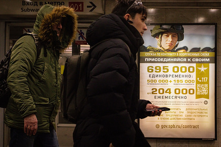 An advertising billboard in St. Petersburg, Russia, displays an image of a Russian military personnel urging individuals to sign a service contract with the Ministry of Defense of the Russian Federation. The inscription 'Join yours' encourages participation in a special military operation on the territory of Ukraine.