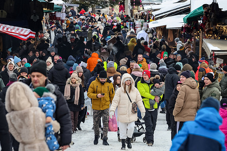 Crowds walk on an open market space at the foot of Gubalowka mountain in the center of Zakopane, a popular Tatra mountain holiday resort.