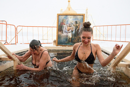 Women are seen during Epiphany bathing in the font on the territory of the Peter and Paul Fortress in St. Petersburg. Russia commemorates one of the significant Christian holidays - Epiphany. Despite the harsh winter conditions, thousands of believers across the country immerse themselves in the font as part of the celebration.