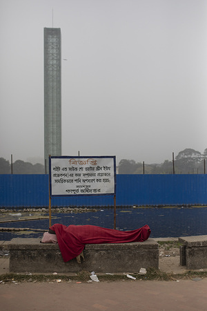 A homeless man covers himself with a blanket in Sohrawardy Udyan due to foggy weather in Dhaka. Suhrawardy Udyan, formerly known as Ramna Race Course ground, stands as a national memorial located in Shahbagh in Dhaka. Dhaka records season's lowest temperature 12.5°C On 22 January 2024 morning.