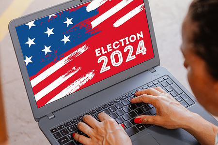 In this photo illustration, the US election 2024 logo seen displayed on a laptop.