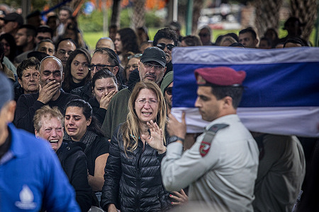 Mourners cry during the funeral ceremony of Major Ilay Levi, at the Tel Aviv military cemetery. Major, Ilay Levi, 24, was killed in battle in the southern Gaza Strip. Twenty-four Israeli soldiers were killed in Gaza on Monday, by far the biggest one-day Israeli death toll in the three-month war against Hamas. The deaths were reported as talks about a ceasefire intensified and Palestinian casualties continued to climb.
The deaths came amid fierce fighting around the southern city of Khan Younis, with dozens of Palestinians killed and wounded. The Israeli casualties are likely to increase domestic pressure on Benjamin Netanyahu over his leadership and handling of the war effort.