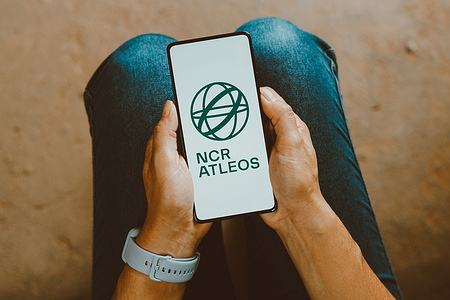 In this photo illustration, the NCR Atleos logo is displayed on a smartphone screen.