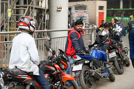 Ridesharing motorbike riders wait for passengers in Dhaka.
