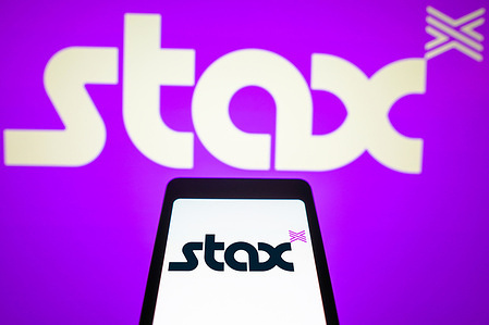 In this photo illustration, the Stax Payments logo is displayed on a smartphone screen and in the background.
