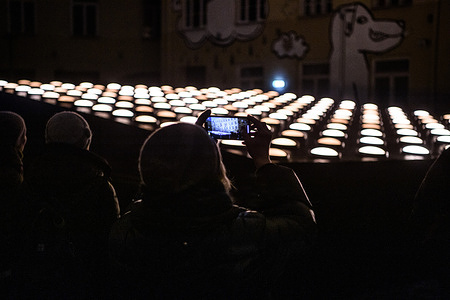 People watch the light installation 'Flux' by Collectif Scale from France at Church of St. Catherine during the Vilnius Light Festival . The traditional annual Vilnius Light Festival is held this year from January 25 to 28. The program of the festival includes 20 light installations from Lithuanian and foreign artists.