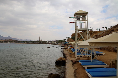 Sun beds where tourists relax on the beach of the bay of Sharm el-Maya, on the shore of the Red Sea in Sharm El Sheikh, Egypt.