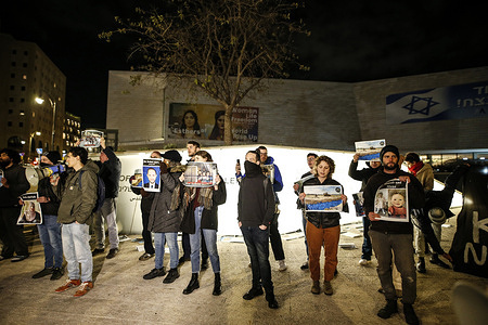 Israeli activists hold placards during the demonstration. Around 20 Israeli activists gathered in front of the Museum of Tolerance Jerusalem (MOTJ) to protest against the Israel-Hamas war and call for a ceasefire.