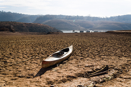 A Pedal boat is seen on the dry soil at the Sau water reservoir. Catalonia declared a state of emergency on Thursday, February 1, as water reservoir levels dropped below 16% of total capacity. Strict measures will limit water usage for public infrastructure and private companies, impacting over 6 million people. The drought, attributed to climate change, is a major factor affecting regions in Spain and the Mediterranean.