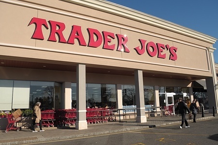 People are seen in front of a Trader Joe's grocery market in the neighborhood of Plainview in Nassau County, Long Island, New York.