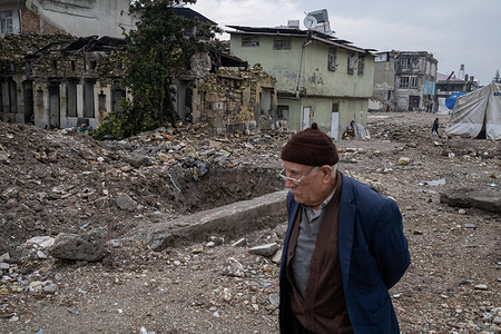 An old man walks past the building damaged by the earthquake. On February 6, 2023, a magnitude 7.8 earthquake occurred in southern Turkey, followed by another magnitude 7.5 tremor just after noon. More than 50,000 people lost their lives in the earthquake that caused great destruction in 11 cities of Turkey.