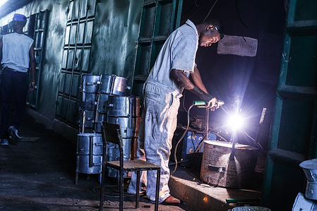 A welder works at his workshop at The Bama Artisan Market in Nakuru. Kenya's informal sector, known as "Jua Kali", employs over 15 million Kenyans with skills in artisan work.