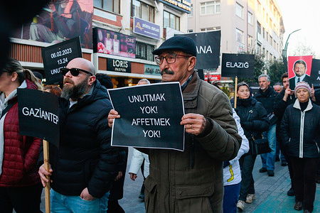 Protesters carry placards expressing their opinion and a portrait of Can Atalay during the demonstration. A protest march and press statement were held in Bolu to honor those who lost their lives in the earthquakes on February 6, 2023.